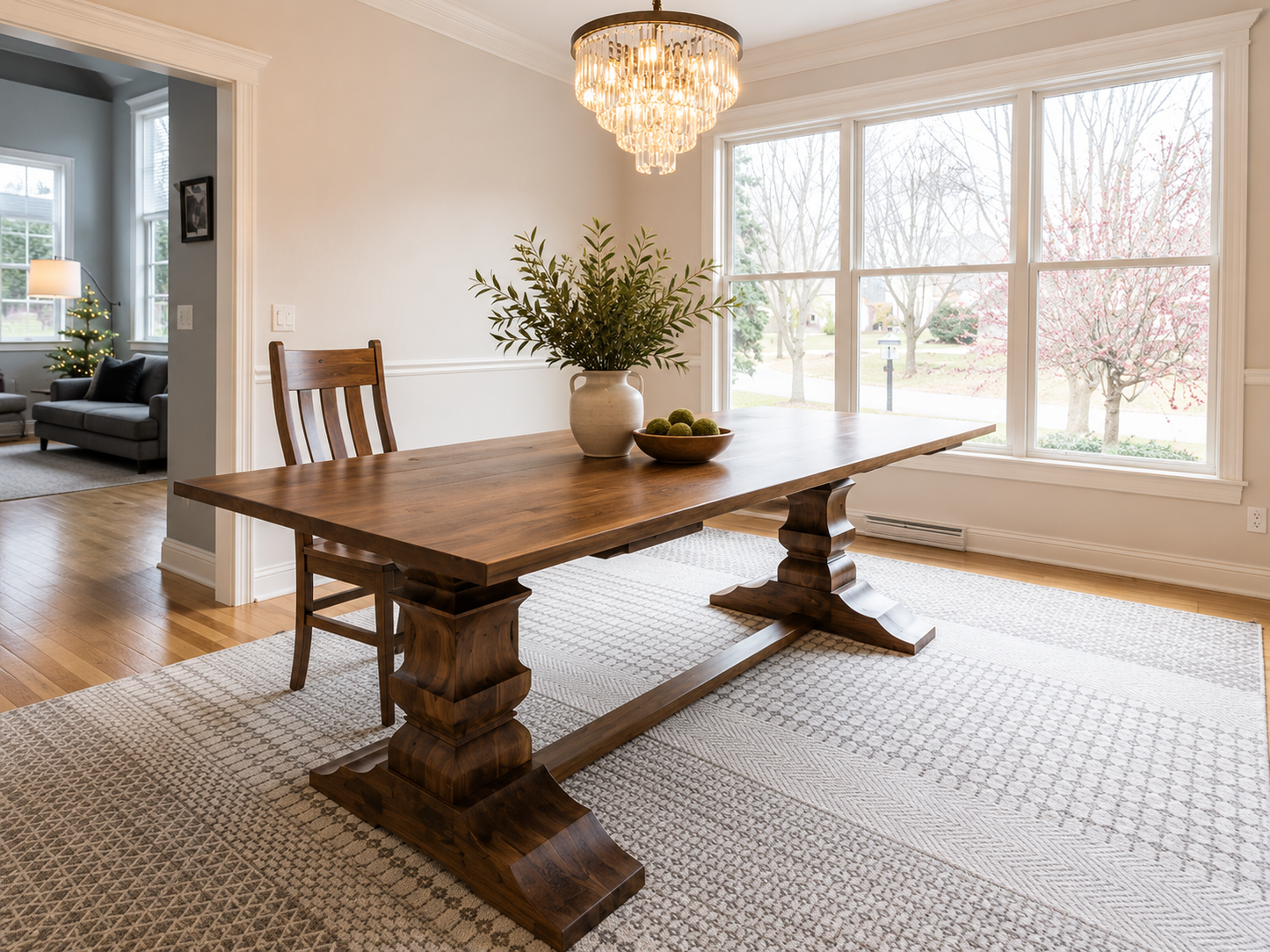 Dark walnut trestle dining table with thick pedestal base and rectangular tabletop