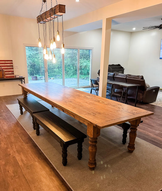 Large farmhouse dining table with turned legs and rustic wood tabletop