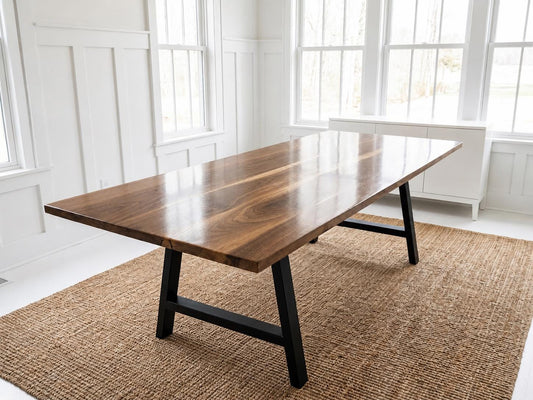 Walnut dining table with black metal legs, rectangular top, straight edge