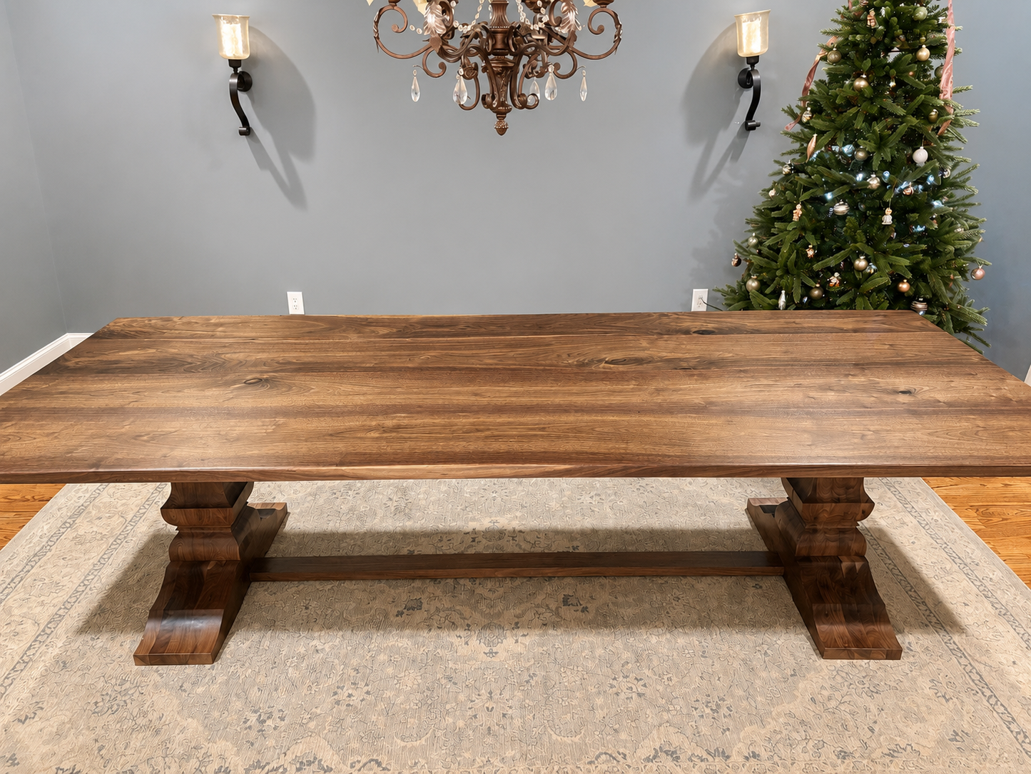 Large walnut dining table with thick tabletop and sturdy trestle legs